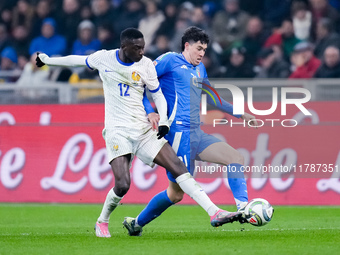 Alessandro Bastoni of Italy and Randal Kolo Muani of France compete for the ball during the UEFA Nations League 2024/25 League A Group 2 mat...