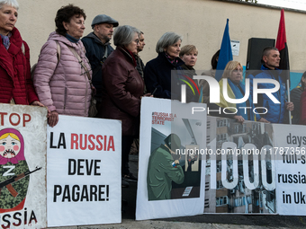 Protesters hold signs as they gather to participate in a demonstration marking the upcoming anniversary of 1,000 days since Russia's invasio...