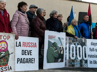 Protesters hold signs as they gather to participate in a demonstration marking the upcoming anniversary of 1,000 days since Russia's invasio...