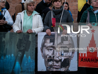 Protesters hold signs as they gather to participate in a demonstration marking the upcoming anniversary of 1,000 days since Russia's invasio...