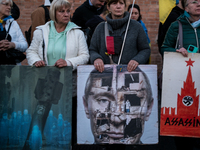 Protesters hold signs as they gather to participate in a demonstration marking the upcoming anniversary of 1,000 days since Russia's invasio...