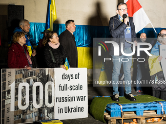 Protesters hold signs as they gather to participate in a demonstration marking the upcoming anniversary of 1,000 days since Russia's invasio...