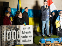 Protesters hold signs as they gather to participate in a demonstration marking the upcoming anniversary of 1,000 days since Russia's invasio...