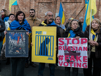 Protesters hold signs as they gather to participate in a demonstration marking the upcoming anniversary of 1,000 days since Russia's invasio...