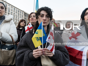 Protesters hold signs as they gather to participate in a demonstration marking the upcoming anniversary of 1,000 days since Russia's invasio...