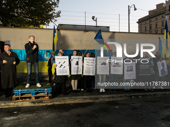 Protesters hold signs as they gather to participate in a demonstration marking the upcoming anniversary of 1,000 days since Russia's invasio...