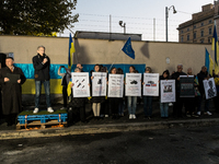 Protesters hold signs as they gather to participate in a demonstration marking the upcoming anniversary of 1,000 days since Russia's invasio...