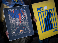 Protesters hold signs as they gather to participate in a demonstration marking the upcoming anniversary of 1,000 days since Russia's invasio...