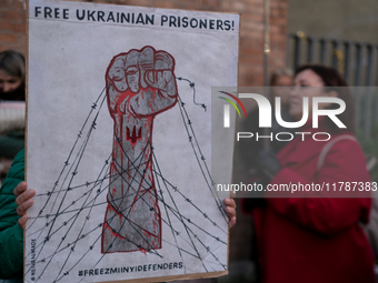 Protesters hold signs as they gather to participate in a demonstration marking the upcoming anniversary of 1,000 days since Russia's invasio...