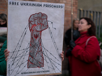 Protesters hold signs as they gather to participate in a demonstration marking the upcoming anniversary of 1,000 days since Russia's invasio...