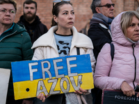 Protesters hold signs as they gather to participate in a demonstration marking the upcoming anniversary of 1,000 days since Russia's invasio...