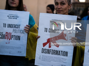 Protesters hold signs as they gather to participate in a demonstration marking the upcoming anniversary of 1,000 days since Russia's invasio...