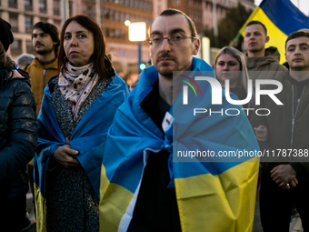 Protesters hold signs as they gather to participate in a demonstration marking the upcoming anniversary of 1,000 days since Russia's invasio...