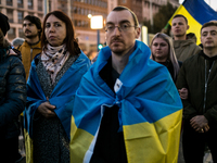 Protesters hold signs as they gather to participate in a demonstration marking the upcoming anniversary of 1,000 days since Russia's invasio...