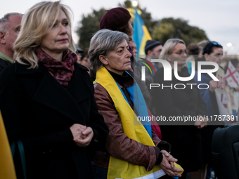 Protesters hold signs as they gather to participate in a demonstration marking the upcoming anniversary of 1,000 days since Russia's invasio...