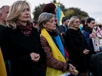 Protesters hold signs as they gather to participate in a demonstration marking the upcoming anniversary of 1,000 days since Russia's invasio...