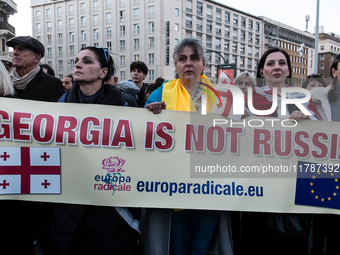 Protesters hold signs as they gather to participate in a demonstration marking the upcoming anniversary of 1,000 days since Russia's invasio...