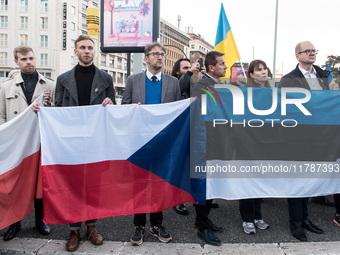 Protesters hold signs as they gather to participate in a demonstration marking the upcoming anniversary of 1,000 days since Russia's invasio...