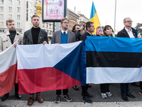 Protesters hold signs as they gather to participate in a demonstration marking the upcoming anniversary of 1,000 days since Russia's invasio...