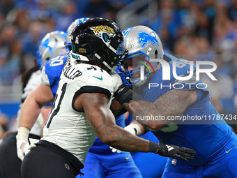 DETROIT,MICHIGAN-November 17: Detroit Lions offensive tackle Taylor Decker (68) defends against Jacksonville Jaguars defensive end Josh Hine...