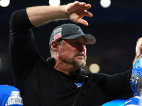 DETROIT,MICHIGAN-November 17: Detroit Lions head coach Dan Campbell celebrates with players after a touchdown during the second half of an N...