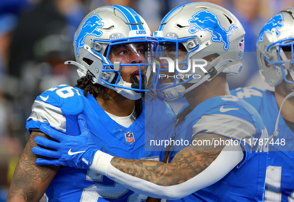 DETROIT,MICHIGAN-NOVEMBER17:  Running back Jahmyr Gibbs (26) of the Detroit Lions celebrates a touchdown with running back David Montgomery...