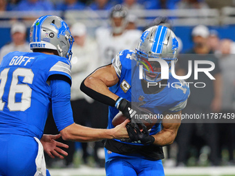 DETROIT,MICHIGAN-November 17: Detroit Lions quarterback Jared Goff (16) handles the ball off to wide receiver Amon-Ra St. Brown (14) during...