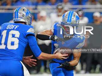 DETROIT,MICHIGAN-November 17: Detroit Lions quarterback Jared Goff (16) handles the ball off to wide receiver Amon-Ra St. Brown (14) during...