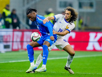 Destiny Udogie of Italy and Matteo Guendouzi of France compete for the ball during the UEFA Nations League 2024/25 League A Group 2 match be...