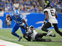 DETROIT,MICHIGAN-November 17: Detroit Lions running back Jahmyr Gibbs (26) runs the ball against Jacksonville Jaguars cornerback Montaric Br...