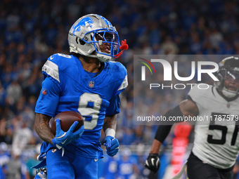 DETROIT,MICHIGAN-November 17: Detroit Lions wide receiver Jameson Williams (9) runs the ball for a touchdown during the second half of an NF...