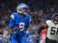 DETROIT,MICHIGAN-November 17: Detroit Lions wide receiver Jameson Williams (9) runs the ball for a touchdown during the second half of an NF...