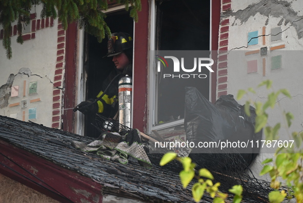 Debris is removed from the home at the scene in Queens Village, New York, United States, on November 17, 2024. One person is killed in a fir...