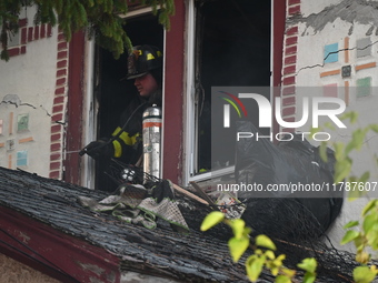 Debris is removed from the home at the scene in Queens Village, New York, United States, on November 17, 2024. One person is killed in a fir...