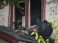 Debris is removed from the home at the scene in Queens Village, New York, United States, on November 17, 2024. One person is killed in a fir...