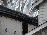 Flames come from the home on Sunday afternoon in Queens Village. One person is killed in a fire that affects a residence at 218-59 110th Ave...