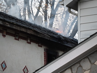 Flames come from the home on Sunday afternoon in Queens Village. One person is killed in a fire that affects a residence at 218-59 110th Ave...