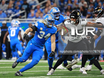 DETROIT,MICHIGAN-November 17: Jacksonville Jaguars tight end Brenton Strange (85) defends against Detroit Lions linebacker Alex Anzalone (34...