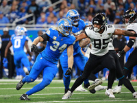 DETROIT,MICHIGAN-November 17: Jacksonville Jaguars tight end Brenton Strange (85) defends against Detroit Lions linebacker Alex Anzalone (34...