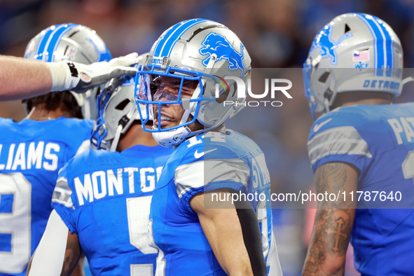 DETROIT,MICHIGAN-NOVEMBER17:  Wide receiver Amon-Ra St. Brown (14) of the Detroit Lions reacts after a Lions touchdown during a game between...