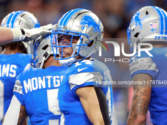 DETROIT,MICHIGAN-NOVEMBER17:  Wide receiver Amon-Ra St. Brown (14) of the Detroit Lions reacts after a Lions touchdown during a game between...