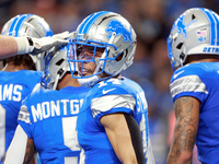 DETROIT,MICHIGAN-NOVEMBER17:  Wide receiver Amon-Ra St. Brown (14) of the Detroit Lions reacts after a Lions touchdown during a game between...