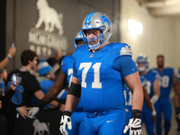 DETROIT,MICHIGAN-November 17: Detroit Lions guard Kevin Zeitler (71) heads to the field in the tunnel during an NFL football game between th...