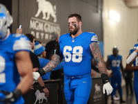 DETROIT,MICHIGAN-November 17: Detroit Lions offensive tackle Taylor Decker (68) heads to the field in the tunnel during an NFL football game...