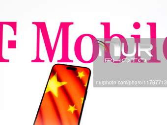 The T-Mobile logo and a Chinese flag are seen in this illustration photo taken in Warsaw, Poland on 17 November, 2024. T-Mobile is one of se...