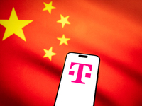 The T-Mobile logo and a Chinese flag are seen in this illustration photo taken in Warsaw, Poland on 17 November, 2024. T-Mobile is one of se...