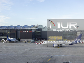 SAS Connect Airbus A320neo aircraft spotted taxiing at London Heathrow Airport LHR in front of the terminal and the air control tower. The m...