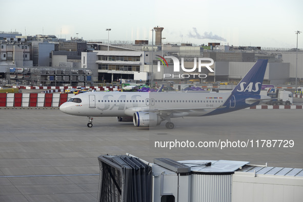 SAS Connect Airbus A320neo aircraft spotted taxiing at London Heathrow Airport LHR in front of the terminal and the air control tower. The m...