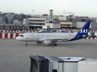 SAS Connect Airbus A320neo aircraft spotted taxiing at London Heathrow Airport LHR in front of the terminal and the air control tower. The m...