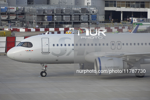 SAS Connect Airbus A320neo aircraft spotted taxiing at London Heathrow Airport LHR in front of the terminal and the air control tower. The m...